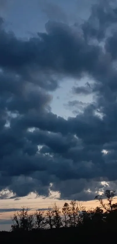 Moody evening sky with dark clouds at sunset.