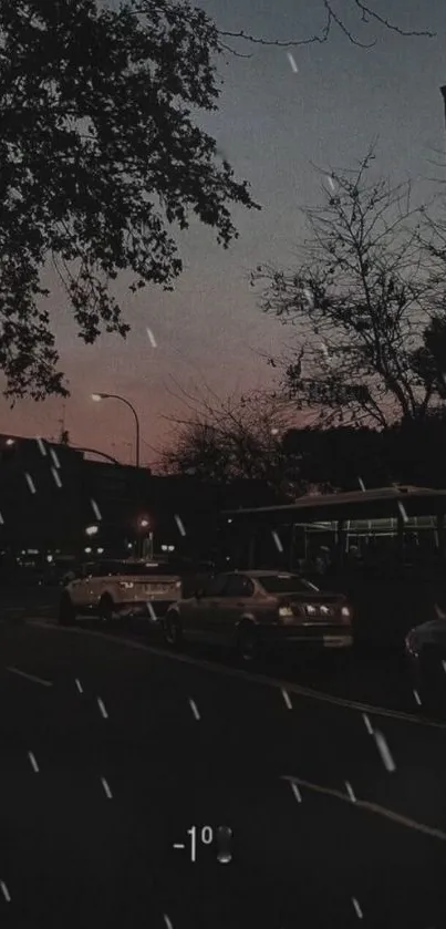 Moody evening street view with cars and rain.