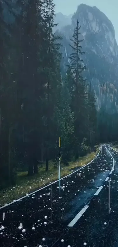 Misty forest road leading to mountains under a dark sky.