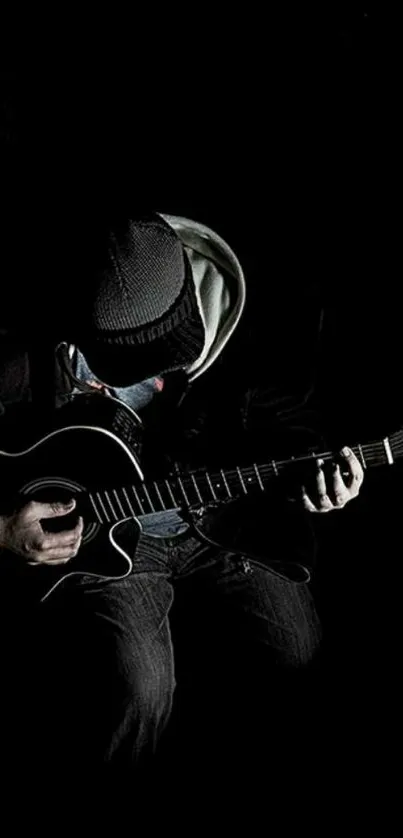 Guitarist playing in the dark, creating a moody atmosphere.