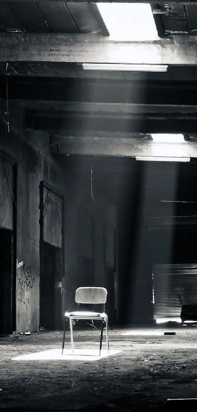 A moody industrial warehouse with a spotlight on a lone chair.