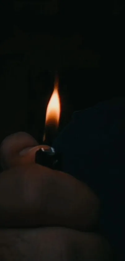 Hand holding a lighter, creating a dark and moody atmosphere.