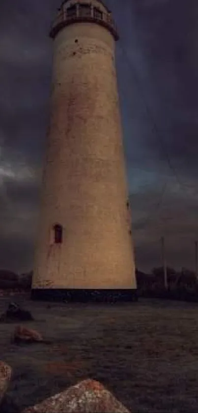 Lone lighthouse under dark moody sky on a rocky coastal landscape.