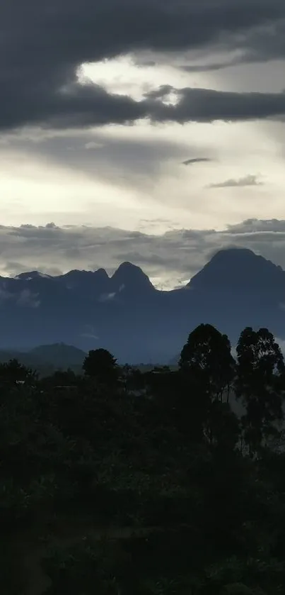 Misty mountains under a dramatic gray sky with clouds.