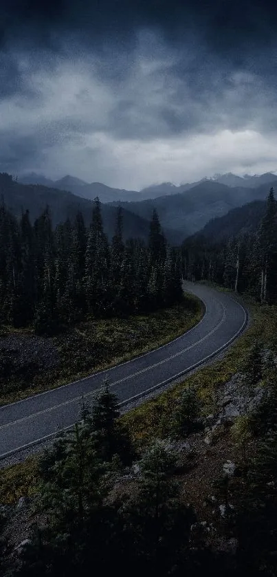 A winding road through a dark forest with mountains and moody sky.