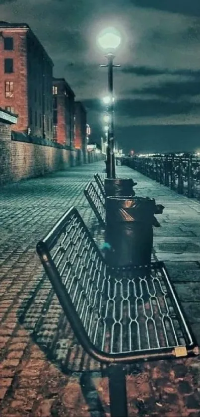 Moody night street with cobblestones and glowing streetlights.