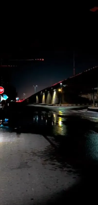 Moody night scene with wet street and reflections.