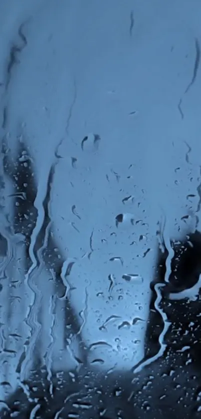 Raindrops on a window with a blue background, creating a moody mobile wallpaper.