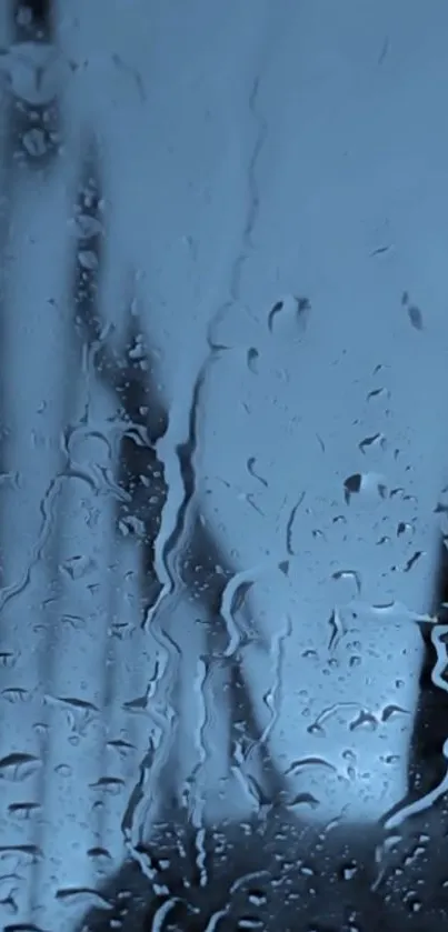 Moody blue rain-soaked window wallpaper with water droplets.