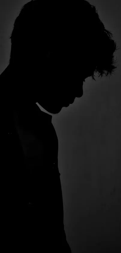 Silhouette of a person in dim light, creating a moody aesthetic.