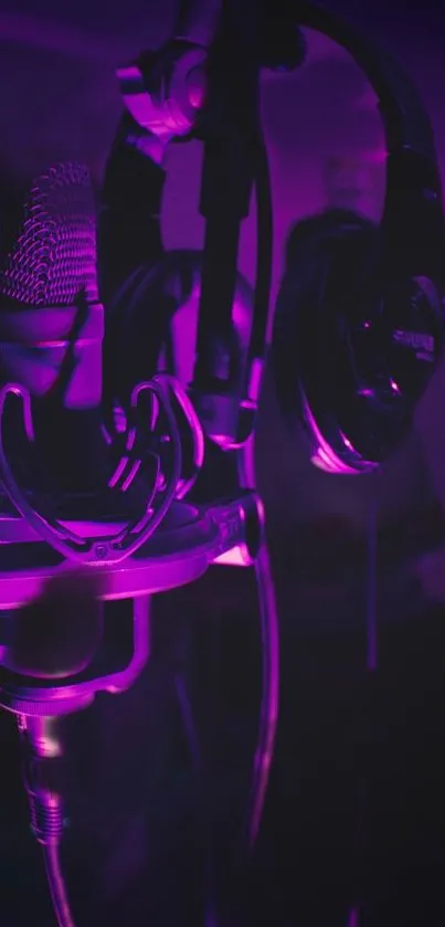 Purple lit studio setup with headphones and microphone.