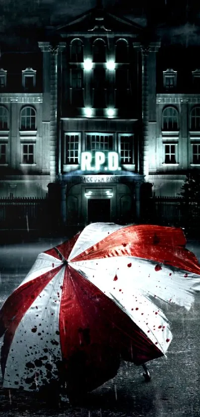 Red and white umbrella with a dark building backdrop at night.