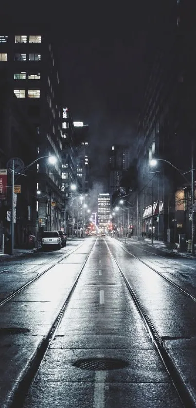 Dark urban street at night with city lights and buildings.