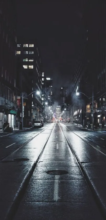 Moody urban nightscape with empty street and glowing city lights.