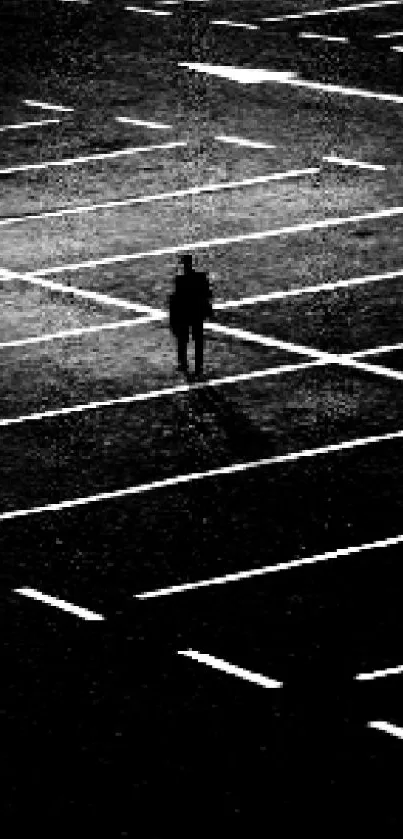 Silhouette in an empty parking lot at night.