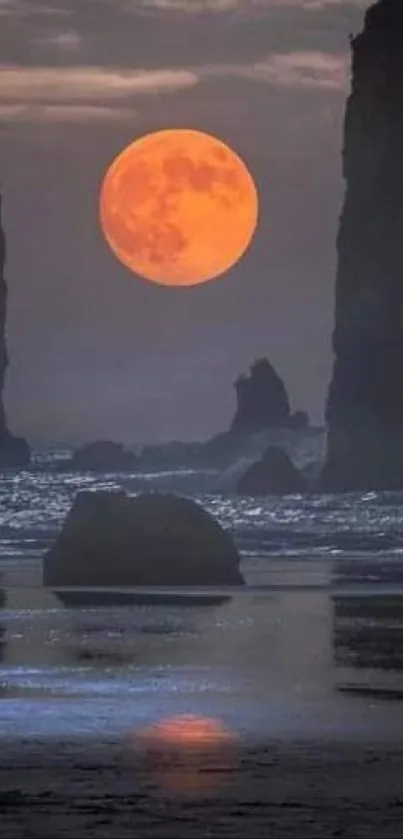 Vibrant orange moon between cliffs over ocean at night.