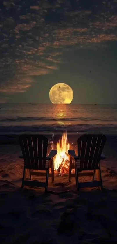 Moonlit beach with fire and chairs against ocean.