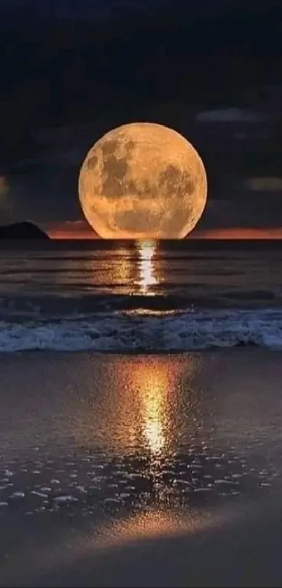 Full moon reflecting on beach waves at night.