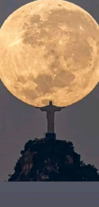 Christ the Redeemer silhouetted by full moon.