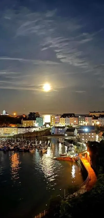 Moonlit harbor with illuminated buildings and calm water reflection at night.