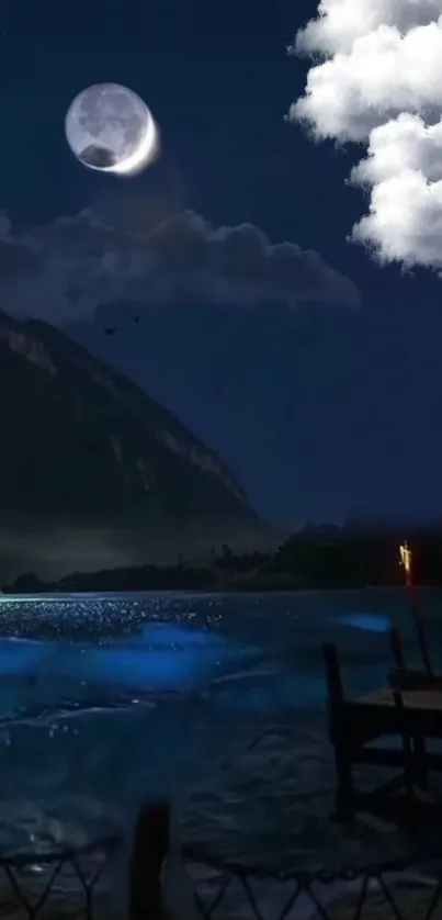 Moonlit lake with clouds and mountains under a starry night sky, creating a serene scene.