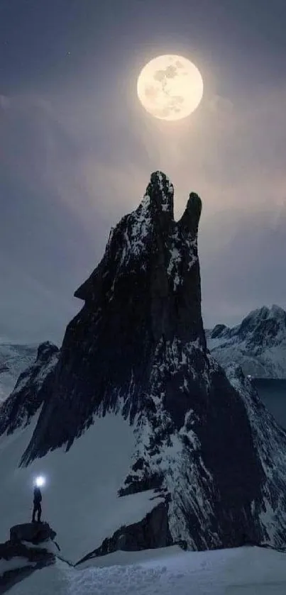 Dramatic moonlight mountain with a climber silhouetted against the night sky.