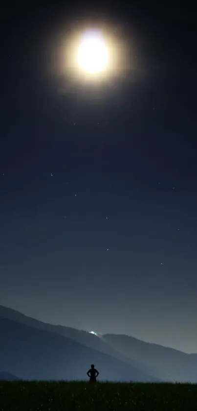 Serene moonlit night landscape with silhouetted mountain and lone figure.