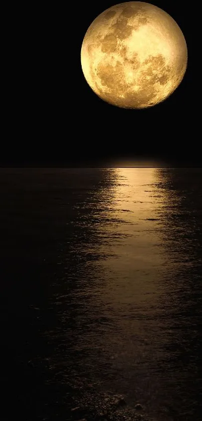 Golden full moon reflected on calm dark water at night.