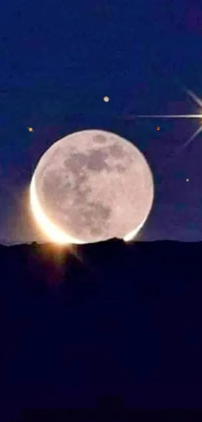 Moon rising over a starry night sky with a bright star in the distance.