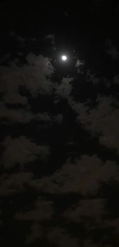 A serene night sky with a bright moon and scattered clouds.