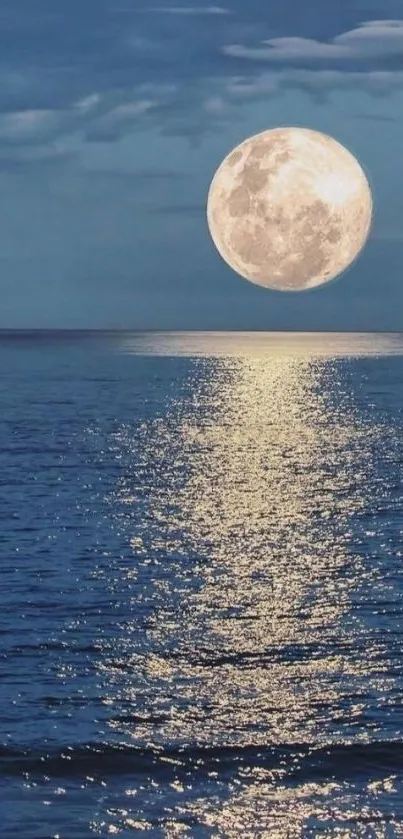 Moon reflecting on a calm ocean with a deep blue sky.