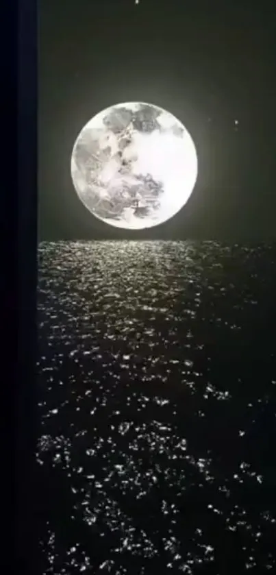 Full moon reflecting over dark ocean waters at night.