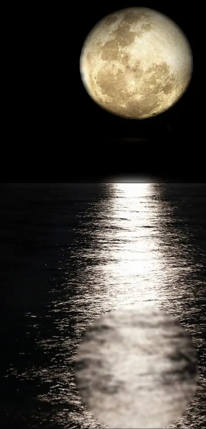 A full moon reflecting on calm waters under a dark night sky.