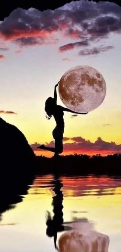 Silhouette holding moon against sunset with water reflection.