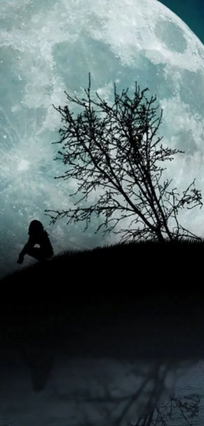 Silhouette of a tree and figure against a large moonlit background.