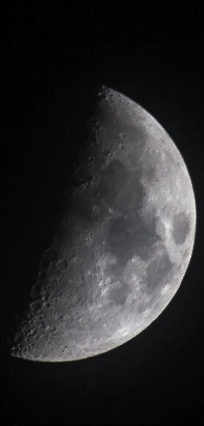 Half moon glowing against a dark sky.