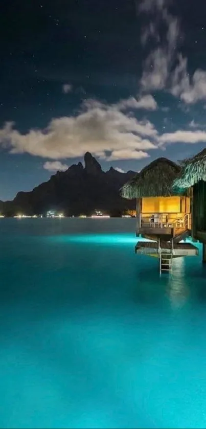 Moonlit tropical bungalow over turquoise water at night.