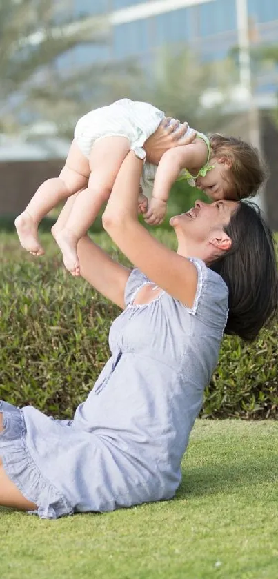 Mother lifting child in green park, joyful moment.