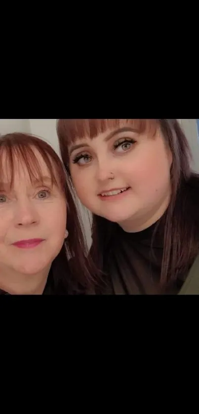 Mother and daughter smiling warmly together.