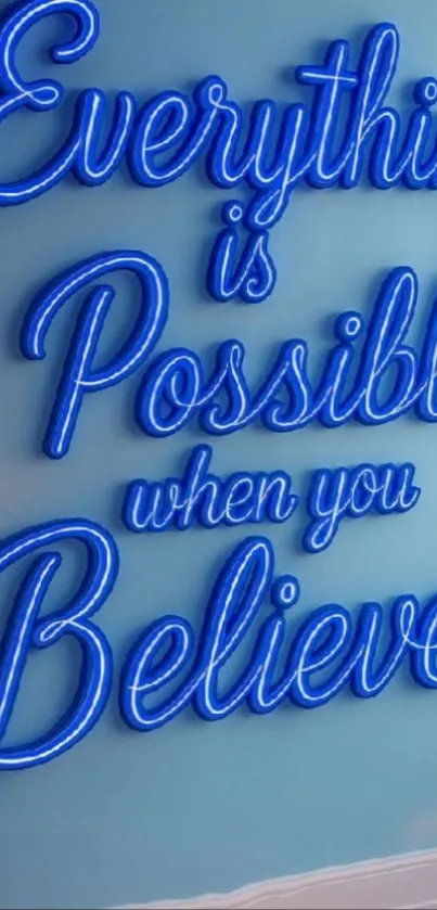 Neon sign saying 'Everything is Possible when you Believe' on a blue wall.