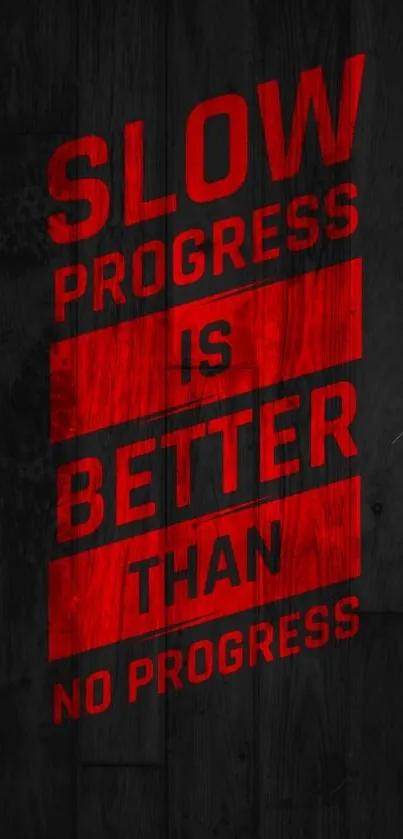 Motivational wallpaper with red text on black wood background.