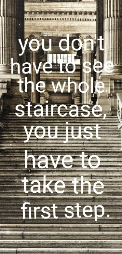 Motivational quote on staircase with statues in classic architecture.