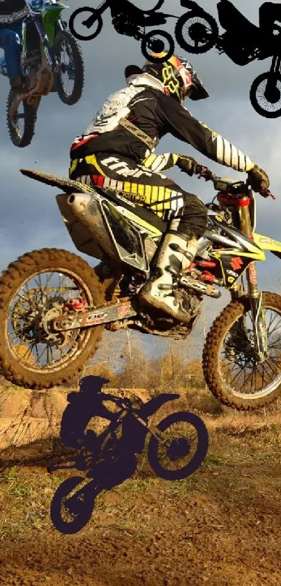 Motocross riders performing jumps in a dramatic landscape with a cloudy sky.