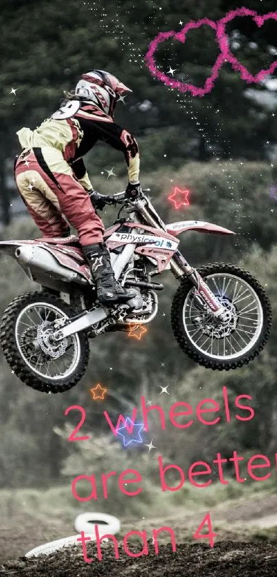 Motocross biker jumps in front of a forest with pink hearts in the sky.