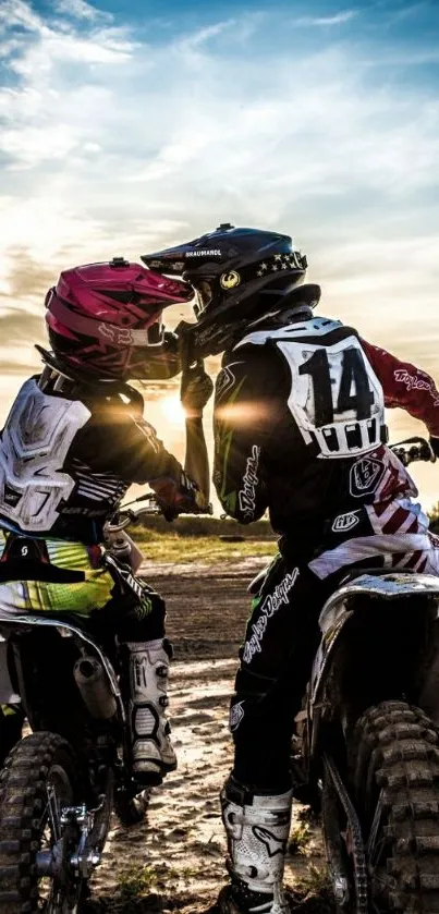 Motocross riders racing at sunset.