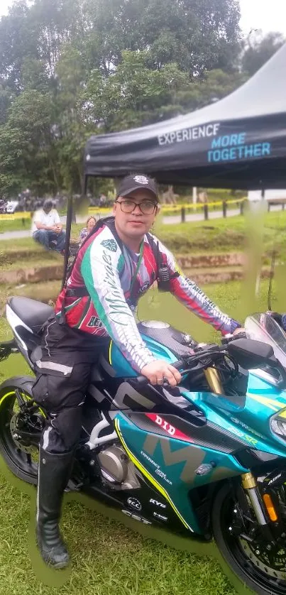 Motocross rider on blue motorcycle in a lush park setting.