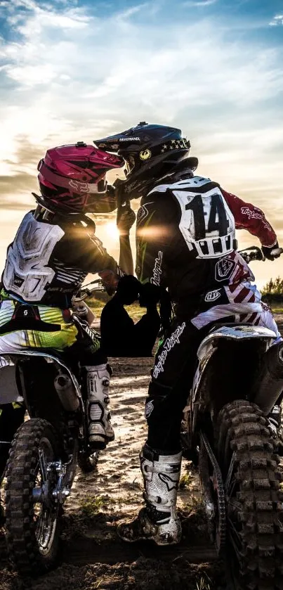 Motocross riders racing at sunset with dramatic sky.