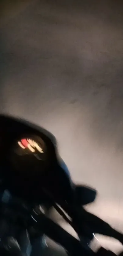 Blurry night-time motorbike dashboard view.