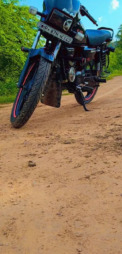 Classic motorbike on a dirt path with lush green trees.