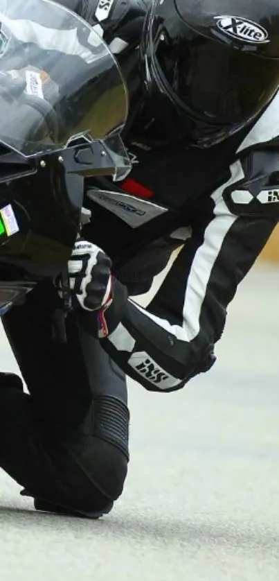 Motorbike racer leaning into a turn on the track, wearing black racing gear.